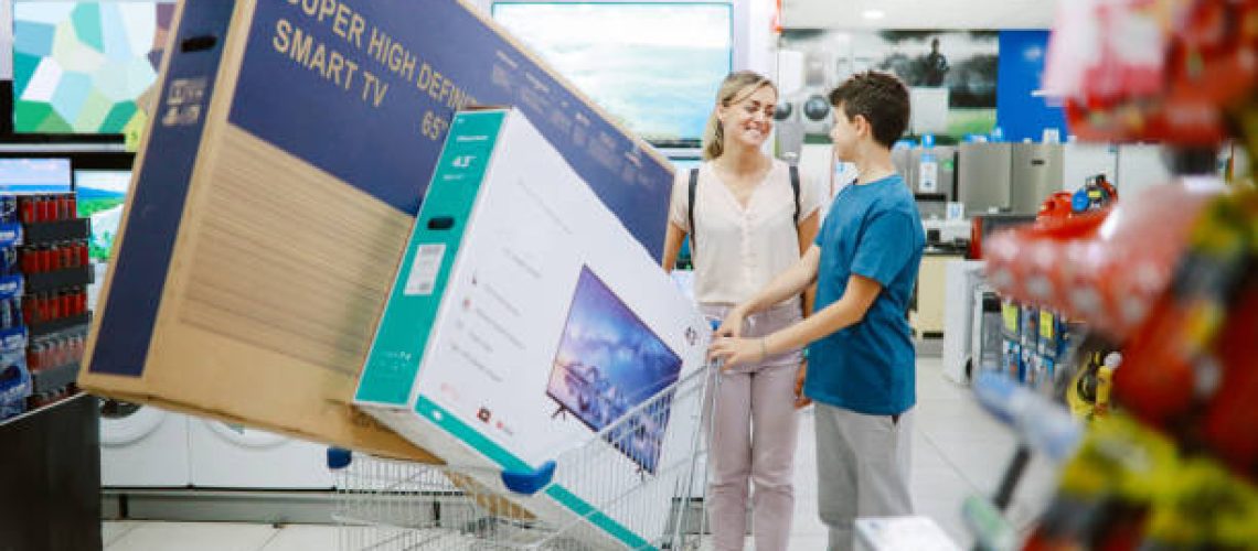 Mom and son buying large TV sets in the shopping mall, taking them out to the parking lot.